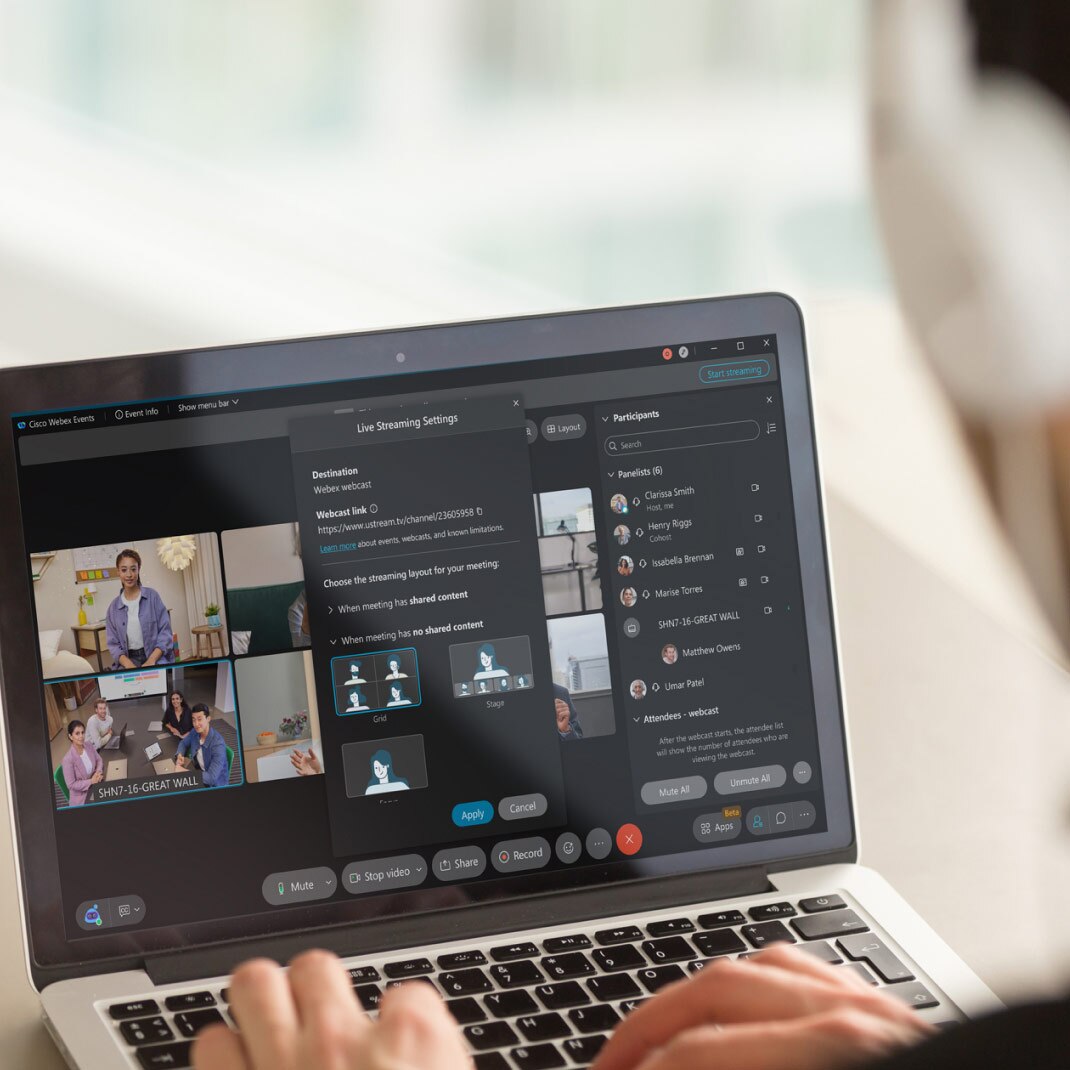 Professional manages a webinar from laptop using Webex Webinars.